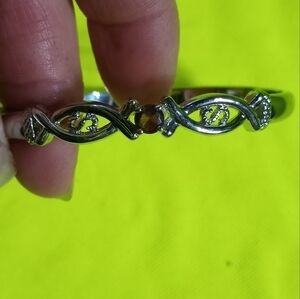 Silvertone hinged pinkish purplish stone bracelet